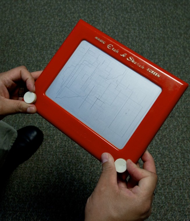 A man plays with an Etch-A-Sketch screen